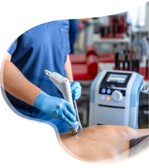 doctor using the extracorporeal shockwave treatment equipment on the patient