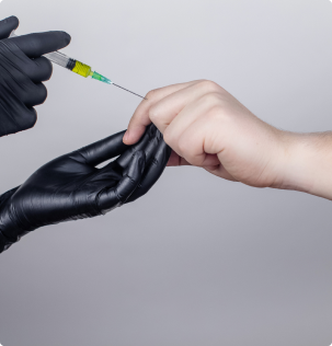 image of a hand making an injection in the finger joint of a person