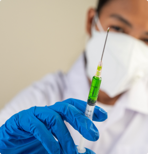 doctor wearing a mask and holding a syringe