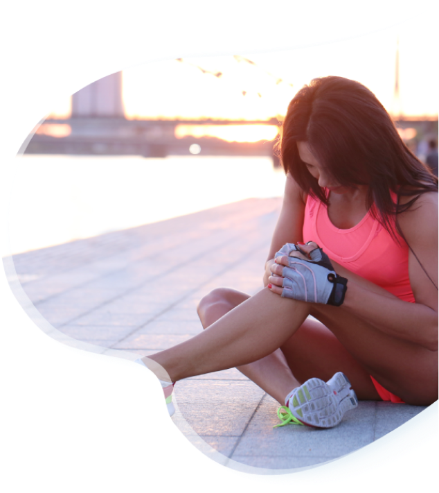 Sportswoman sitting and stretching her knee